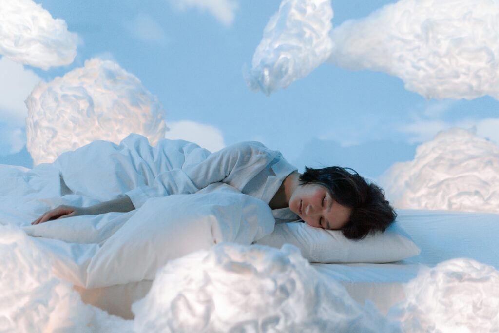 Femme endormie entourée de nuages.